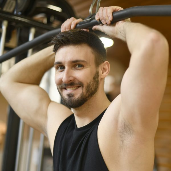 man smiling while doing exercise